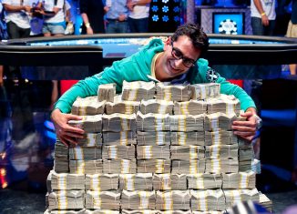 Antonio Esfandiari hugging a stack of $18 million dollars after his Big One for One Drop win in 2012. (Photo: PokerPhotoArchive/Joe Giron)