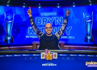 Victorious in U.S. Poker Open Event #7, Bryn Kenney raises his arms aloft.