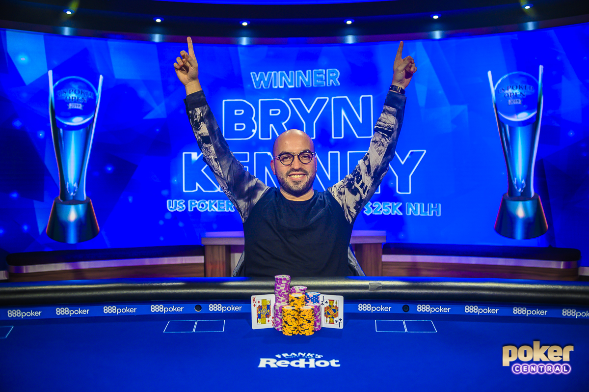 Victorious in U.S. Poker Open Event #7, Bryn Kenney raises his arms aloft.